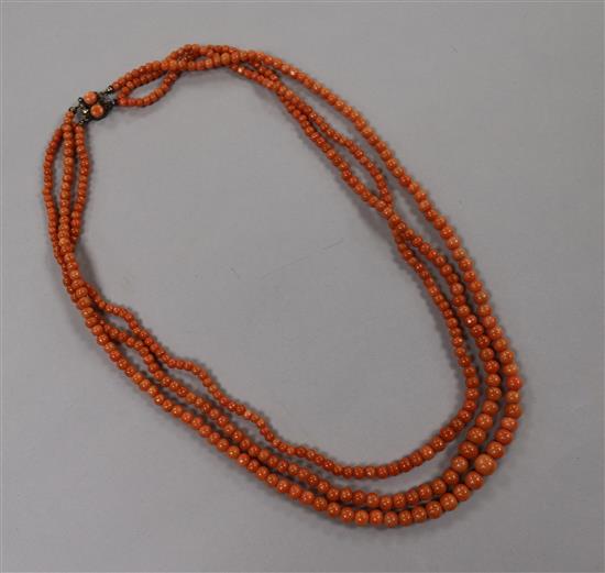 A triple strand graduated coral bead necklace, gross weight 51 grams, 50cm.